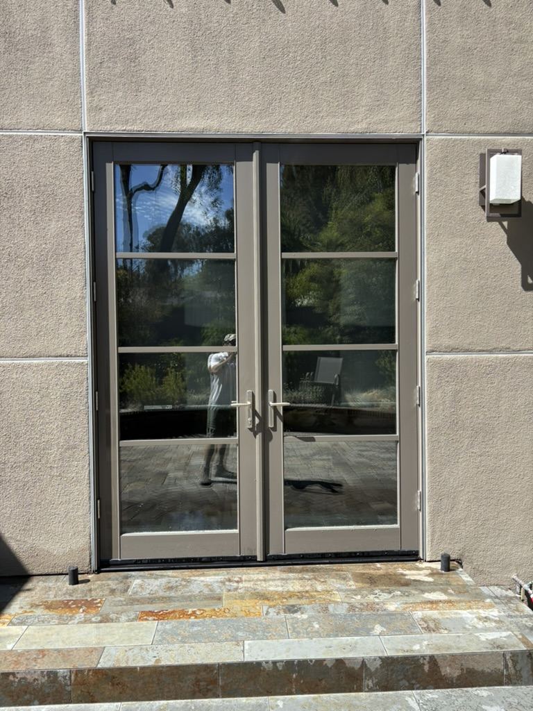 Freshly cleaned French doors with a mirror-clear reflection after pure water washing